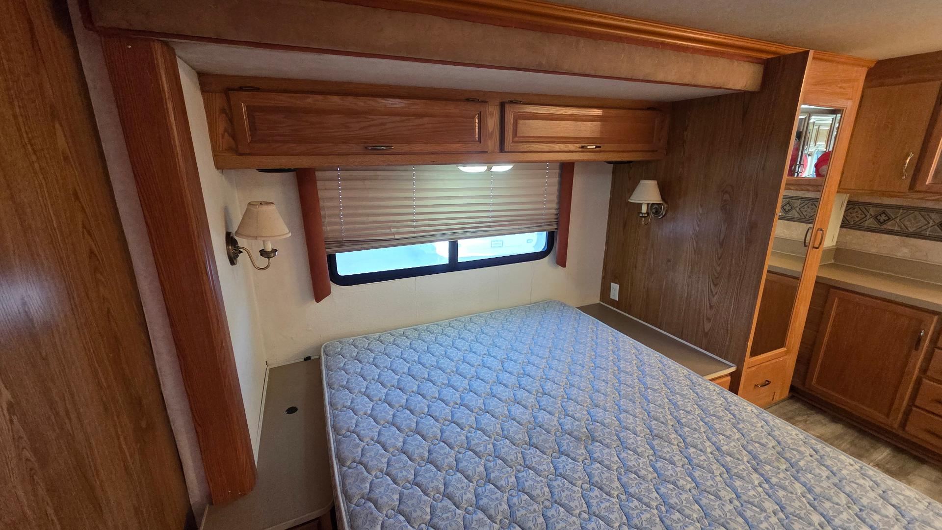 2005 Fleetwood Bounder 35E — rear bedroom with queen bed and overhead cabinets