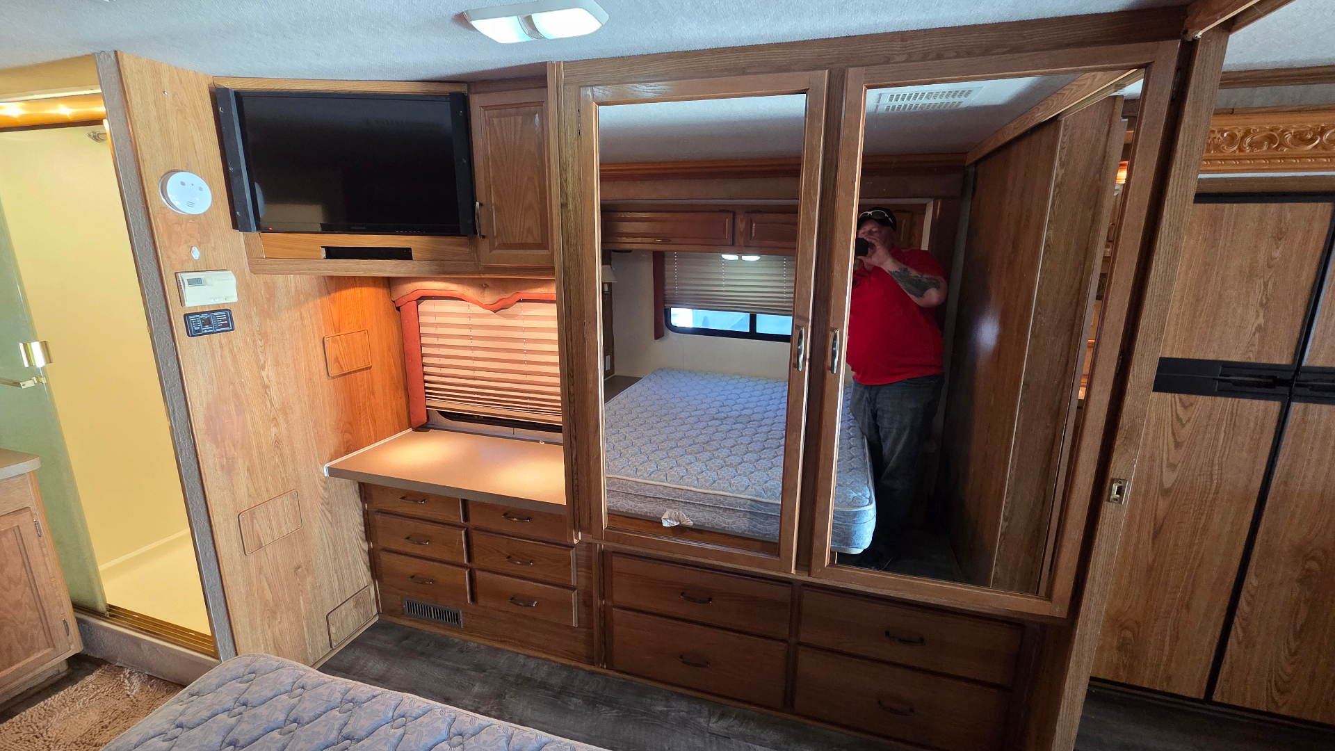 2005 Fleetwood Bounder 35E — bedroom dresser, mirrored wardrobe and TV