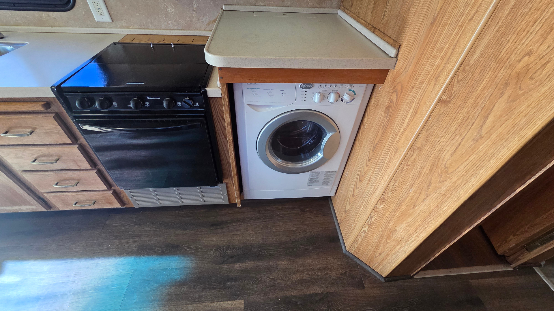 2005 Fleetwood Bounder 35E — galley with cooktop, oven and Splendide washer/dryer combo